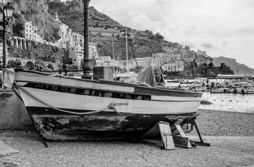 Boat aground with on the background Amalfi and its port, Campania, Italy