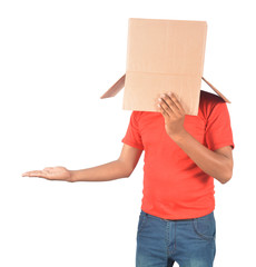 Young man gesturing with a cardboard box on his head isolated on white background
