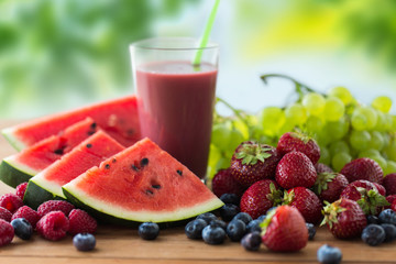 healthy eating, food, dieting and vegetarian concept - glass with fruit and berry juice or smoothie...