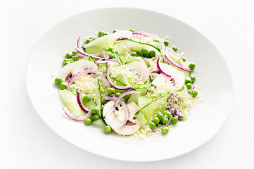 salad with fresh vegetables and raw champignons dressed with oil and white wine vinegar and sprinkled with parmesan 