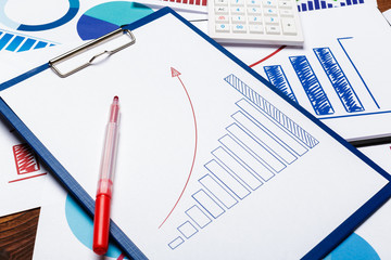 Top view of business paper chart or graph on wooden table