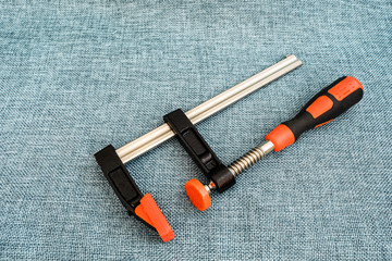 The metal clamp on a wooden carpenter's clamps