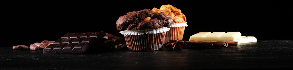 Chocolate muffin and nut muffin, homemade bakery on dark background.