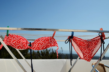 Red polka dot bikini on clothesline