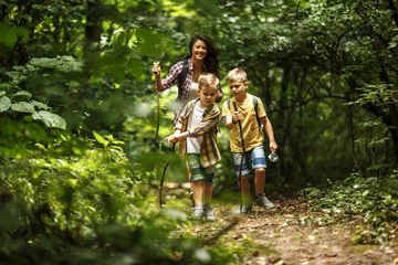 Foto op Canvas Mother and her little sons  hiking trough forest . © BalanceFormCreative