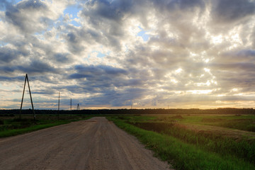 Fototapeta na wymiar Landscape of dirt road in the countryside and beautiful evening sky