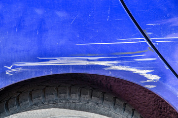 Blue scratched car with damaged paint in crash accident on the street or collision on parking lot in the city © Srdjan