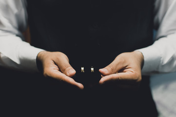 Groom Holding Wedding Rings