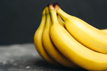 Bunch of bananas on a dark gray background