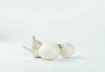 several heads of white onions .isolated on a white
