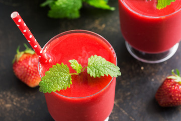 Close-up of strawberry smoothies with mint leaves. Fresh cooling summer drink. Selective focus