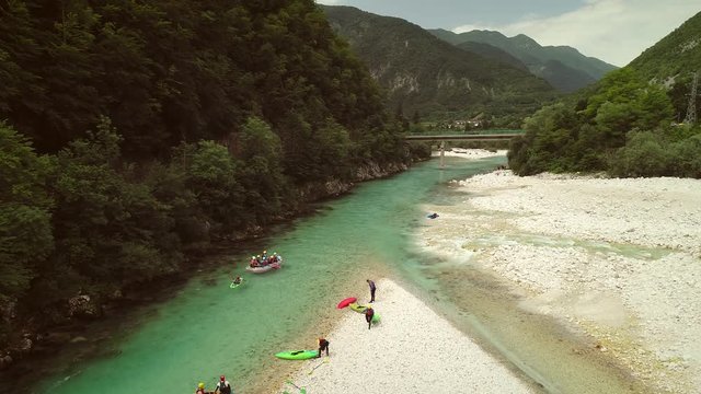 Aerial view of rafters doing rafting in turquoise water going down at Soca river