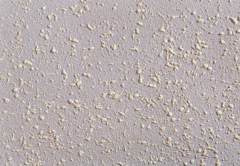 Close-up surface detail of old rough white plaster wall texture, macro.