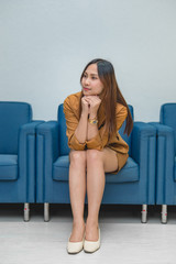 Portrait of beautiful asian business woman wear yellow dress in a office,Thailand people wear ladies uniforms office,Sexy woman on sofa