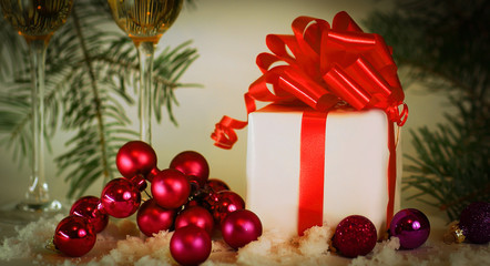 two glasses with champagne, and boxes with gifts on Christmas b