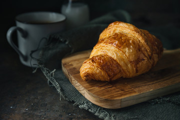 Croissant on rustic background