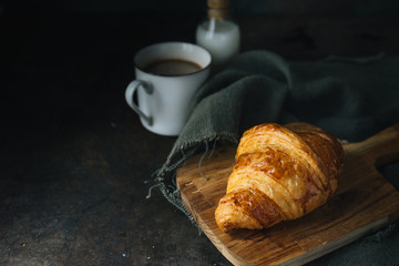 Croissant on rustic background