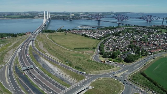 4K aerial footage of traffic on the approach roads to the Queensferry Crossing bridge across the Firth of Forth near Edinburgh.