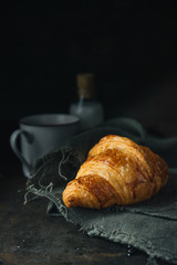 Croissant on rustic background