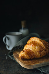 Croissant on rustic background