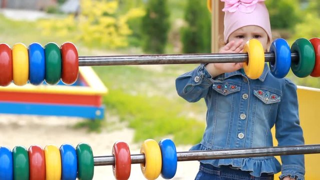 Child girl plays in the playground and learns to count in the game. Development of preschoolers.