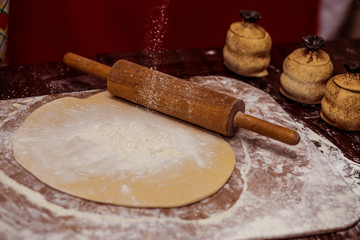 Roll out dough with rolling pin. Making bread. Cooking Process Concept