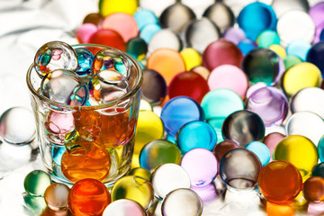 a lot of hydrogel balls on aluminum foil and a vodka pile filled with hydrogel balls
