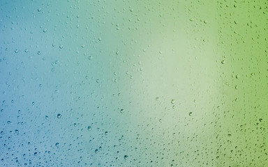 Beautiful colors on the glass soaked in the morning rains. You can see leaking drops on the glass.