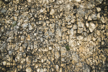 Textured stone background Rubble ballast in natural form in the rock wall