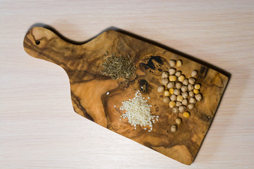 Sesame, chickpeas and cumin on an olive wood board