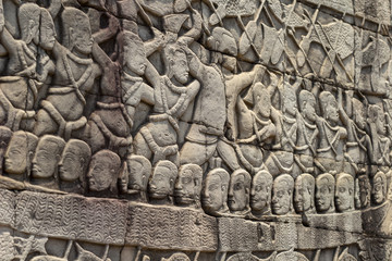 Ancient temple stone carved bas-relief in Angkor Wat. Army in boat bas-relief closeup. Angkor Wat complex Bayon temple