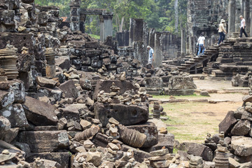 Ancient stone ruin in Angkor Wat temple. Messy stone debris in tourist place. Khmer heritage temple ruin in jungle.
