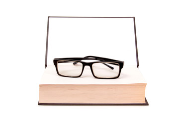 Glasses and old paper books on a white background
