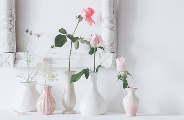still life with pink roses in vase on white background