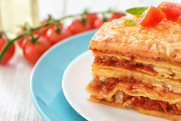 Plate with tasty lasagna on table, closeup