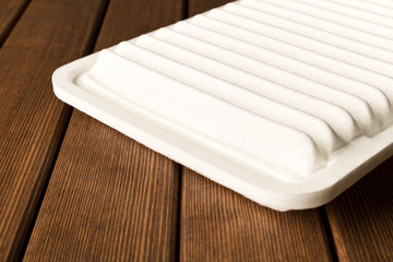 New car air filter on wooden table
