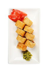 Plate with tasty sushi rolls on white background, top view