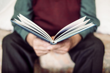 old man reading a book