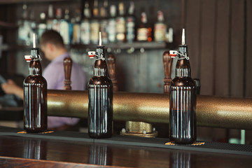 Bottles on counter in modern beer bar