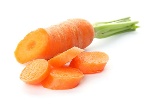 Ripe sliced carrot on white background