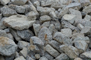 gray stone texture of dirty cobblestones in a heap