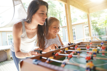 Family playing foosball