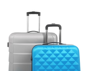 New suitcases packed for journey on white background