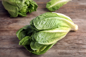 Fresh ripe cos lettuce on wooden table