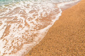 Sandy beach and the waves of the Mediterranean Sea