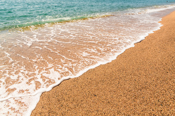 Sandy beach and the waves of the Mediterranean Sea