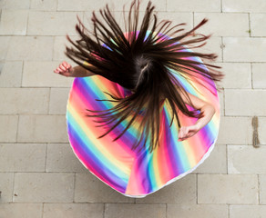 girl in rainbow dress spinning