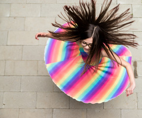 girl in rainbow dress spinning