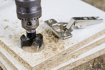 Milling cutter for fixing hinges in chipboard. Joinery accessories for furniture construction.