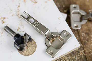 Milling cutter for fixing hinges in chipboard. Joinery accessories for furniture construction.